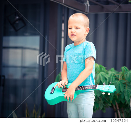 Portrait of a cute boy with ukulele Portrait of a cute boy with ukulele 59547364