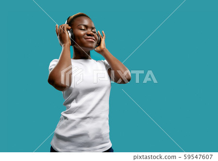 Relaxed female in bluetooth headphones listening music 59547607