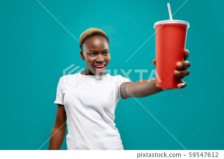 Selective focus of cold drink in hand of african female 59547612