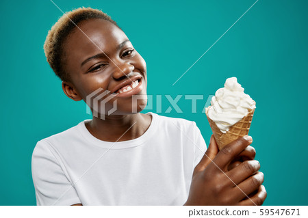 Young woman keeping tasty ice cream and looking at camera 59547671