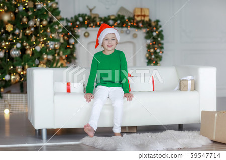 Barefooted boy in white pants on New Year's Eve is lying on the sofa Barefooted boy in white pants on New Year's Eve is lying on the sofa 59547714