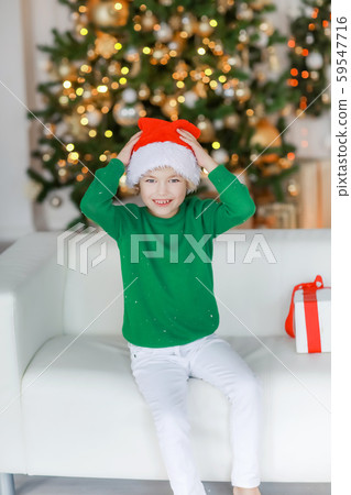 Barefooted boy in white pants on New Year's Eve is lying on the sofa Barefooted boy in white pants on New Year's Eve is lying on the sofa 59547716