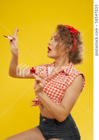 Stylish girl looks satisfied with new selfmade manicure Stylish girl looks satisfied with new selfmade manicure 59547833