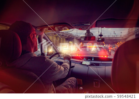 Driving a car in the city at night in traffic jams 59548421