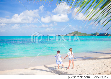 Little girls having fun at tropical beach during summer vacation playing together 59549047