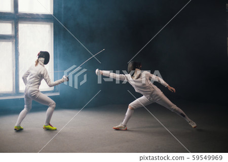 A fencing training - two women having a duel 59549969