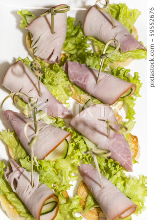 Miniature canapes with meat, vegetables and fish on steel banquet racks. 59552676