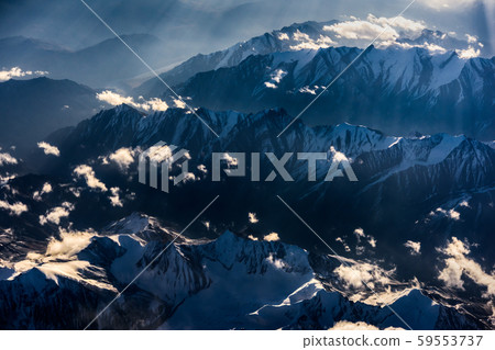 Aerial view of Snow Mountain and light of sunrise on the top himalaya mountains from the plane Aerial view of Snow Mountain and light of sunrise on the top himalaya mountains from the plane 59553737