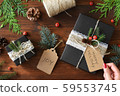 Natural design packaging Christmas gift wrapping and red manicure female hands 59553745