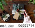 Natural design packaging Christmas gift wrapping and red manicure female hands 59553746