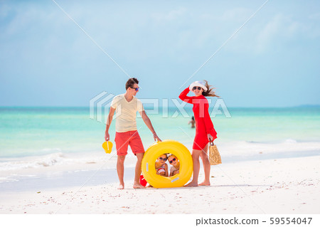 Young family on vacation have a lot of fun together. Parents and kids going to swim 59554047