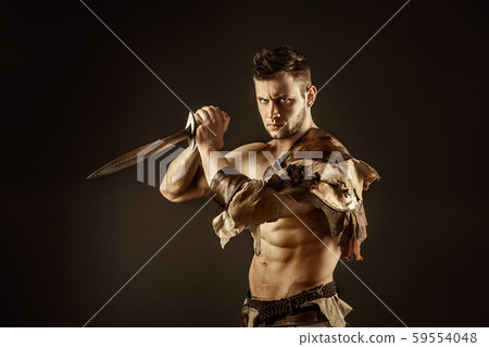 Severe barbarian in leather costume with sword Severe barbarian in leather costume with sword 59554048