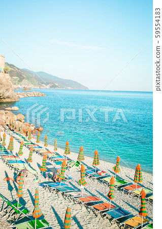 Sunbeds and umbrellas at beautiful european seashore in Monterosso in Italy, Cinque Terre, Liguria Sunbeds and umbrellas at beautiful european seashore in Monterosso in Italy, Cinque Terre, Liguria 59554183