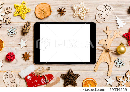 Top view of tablet on holiday wooden background. Top view of tablet on holiday wooden background. 59554339