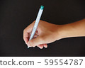Holding a pen to write on a black background 59554787