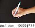 Holding a pen to write on a black background 59554788