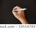 Holding a pen to write on a black background 59554789