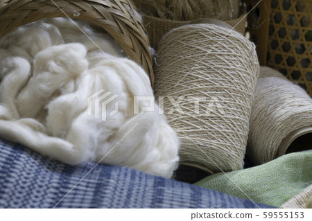 raw cotton thread and cotton fabric in wood tray raw cotton thread and cotton fabric in wood tray 59555153