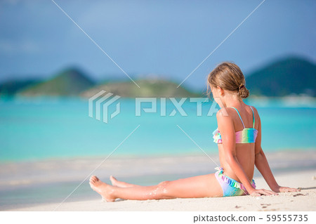 Adorable little girl on the beach during summer vacation Adorable little girl on the beach during summer vacation 59555735