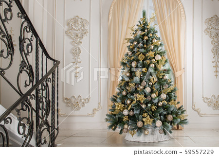Christmas tree in white basket with gold decorations in the interior Christmas tree in white basket with gold decorations in the interior 59557229