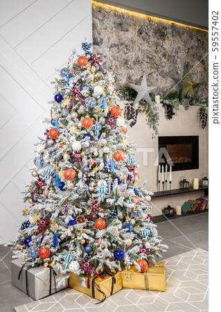 New Year 's white tree with multicolored toys and gifts in the interior New Year 's white tree with multicolored toys and gifts in the interior 59557402