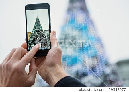 Man is photographing with the smartphone. 59558977