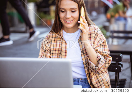 Pretty lady asking for advice of her coworker 59559390