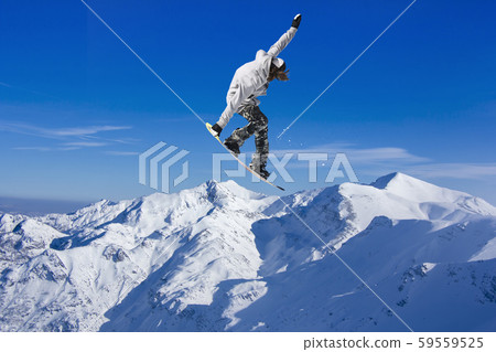 Skier Snowboarder jumping through air with sky in 59559525