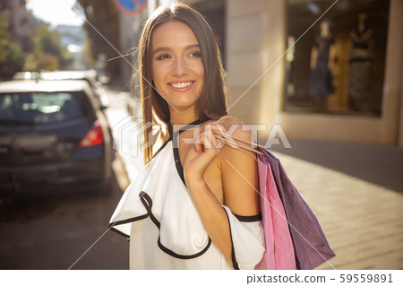 Cheerful pretty lady enjoying the evening sunlight 59559891