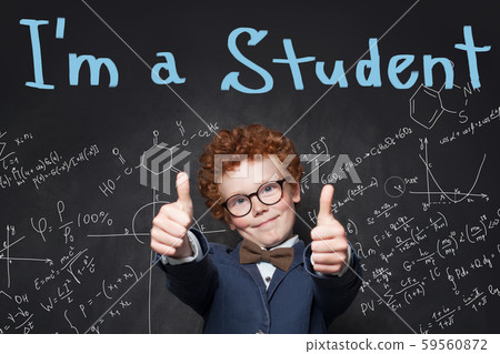 Student boy with thumbs up in classroom. Student boy with thumbs up in classroom. 59560872