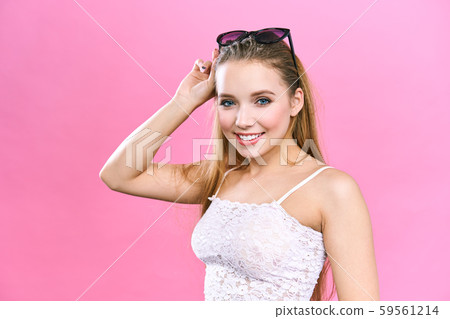 Portrait of charming young blonde woman, looking at camera with cute smile. Student girl relaxing Portrait of charming young blonde woman, looking at camera with cute smile. Student girl relaxing 59561214