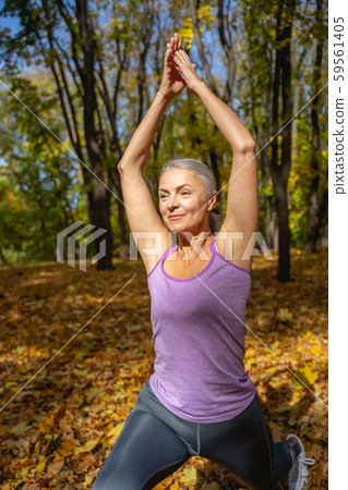 Female yogi performing a crescent lunge asana Female yogi performing a crescent lunge asana 59561405