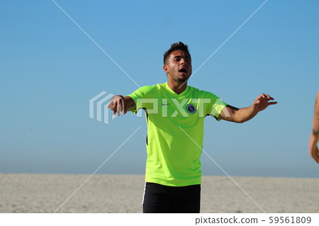 Foreign professional soccer player who decides a disappointing pose against the beach 59561809