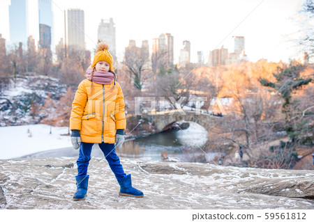Adorable little girl with view of ice-rink in Central Park on Manhattan in New York City 59561812