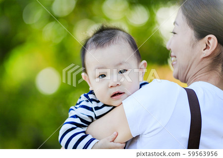 A woman with a baby A woman with a baby 59563956