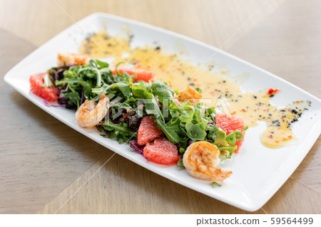 Delicious dish with grilled shrimps, slice grapefruit and arugula salad and spicy fried prawns Delicious dish with grilled shrimps, slice grapefruit and arugula salad and spicy fried prawns 59564499