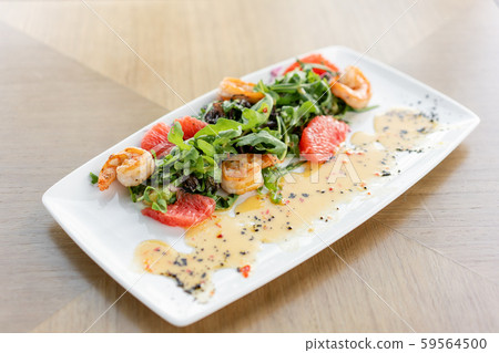 Delicious dish with grilled shrimps, slice grapefruit and arugula salad and spicy fried prawns Delicious dish with grilled shrimps, slice grapefruit and arugula salad and spicy fried prawns 59564500