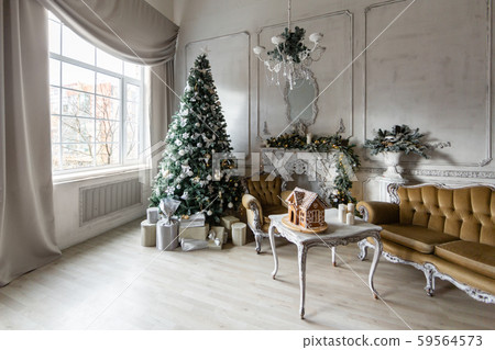Christmas morning. Classic luxury apartments with a white fireplace, christmas tree, sofa, large Christmas morning. Classic luxury apartments with a white fireplace, christmas tree, sofa, large 59564573