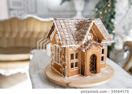Gingerbread house, concept holiday of Christmas and Happy new year. Defocused lights of Christmas Gingerbread house, concept holiday of Christmas and Happy new year. Defocused lights of Christmas 59564578