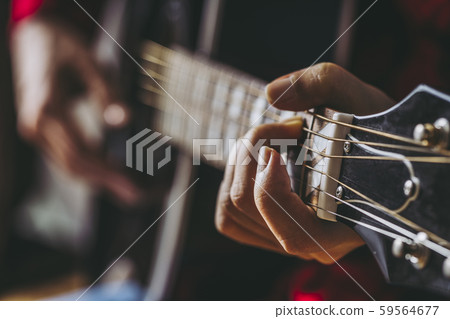Hand of woman playing guitar 59564677