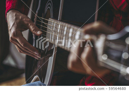 Hand of woman playing guitar 59564680