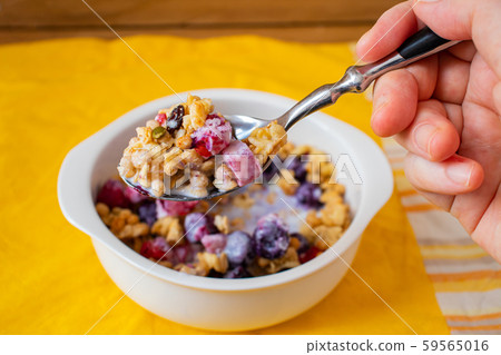 Sprinkle fruit granola with a spoon 59565016