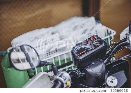 Newspaper delivery and motorcycle Newspaper delivery and motorcycle 59566618