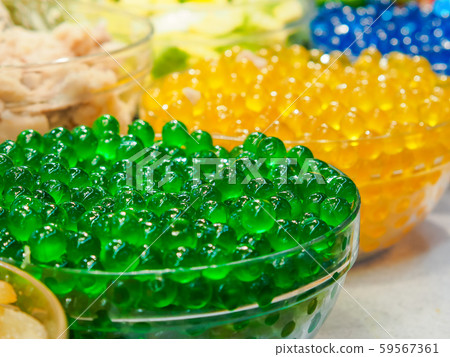 Sweet green jelly bubble in glass bowl. Green tapioca ball or boba. Sweet green jelly bubble in glass bowl. Green tapioca ball or boba. 59567361