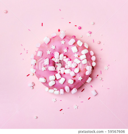 Pink donut with marshmallows and sprinkled. 59567606