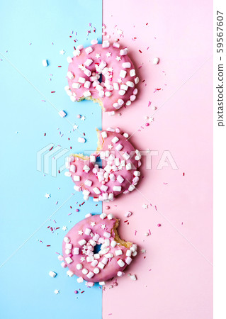 Creative layout made of pink bitten donuts. Food 59567607