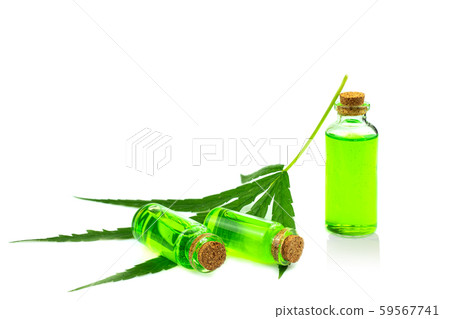 Hand holding a glass bottle with CBD oil and cannabis leaf at the  59567741