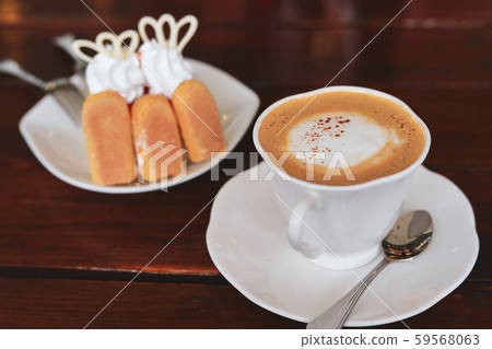 espresso hot coffee drink and orange cake put on breakfast table in the morning espresso hot coffee drink and orange cake put on breakfast table in the morning 59568063