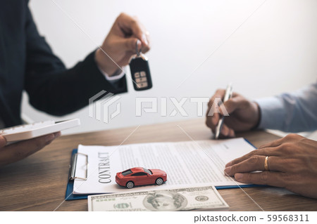 New car buyers sign contract documents for new car New car buyers sign contract documents for new car 59568311