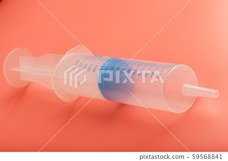 Large medical syringe on pink background with Large medical syringe on pink background with 59568841